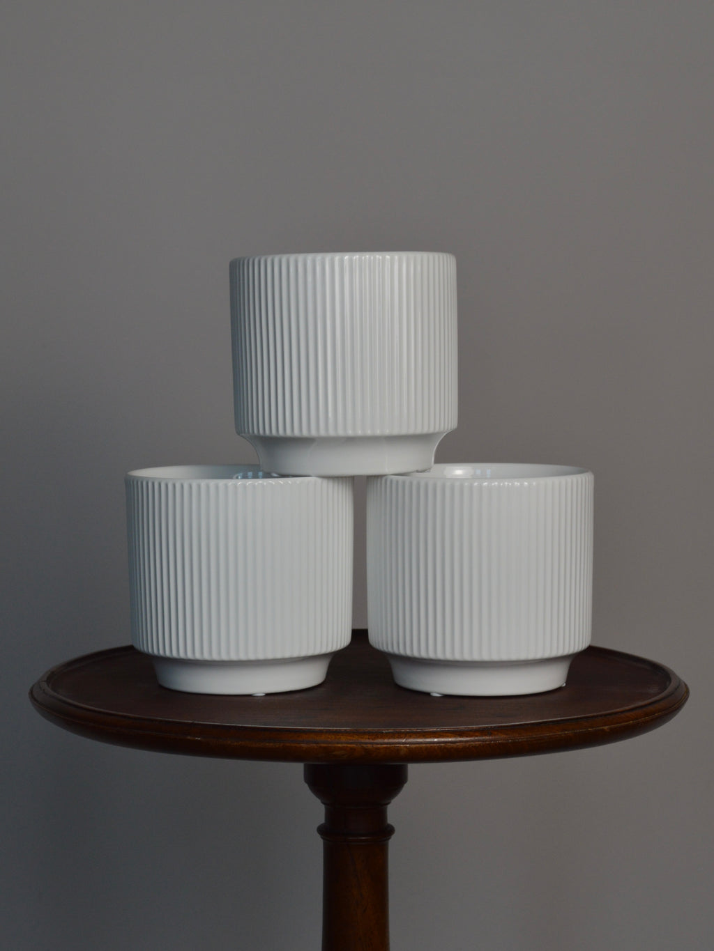 three white glazed ceramic plant pots