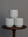 three white glazed ceramic plant pots